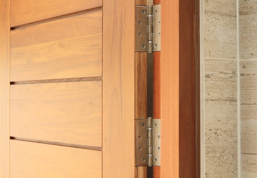 Stainless door hinges on wooden swing door