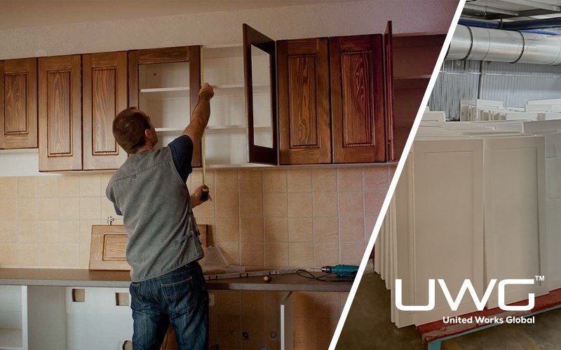Worker installing kitchen cabinet doors with factory cabinet panels