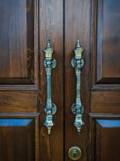 Vintage gold handle on wooden door