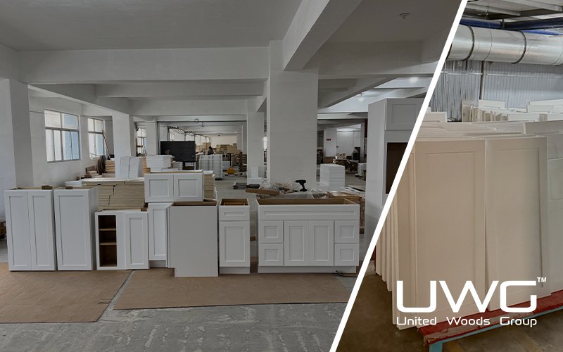 White shaker style kitchen cabinets displayed in a factory workshop