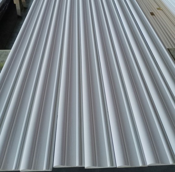 Primed decorative wall panel with linear grooves