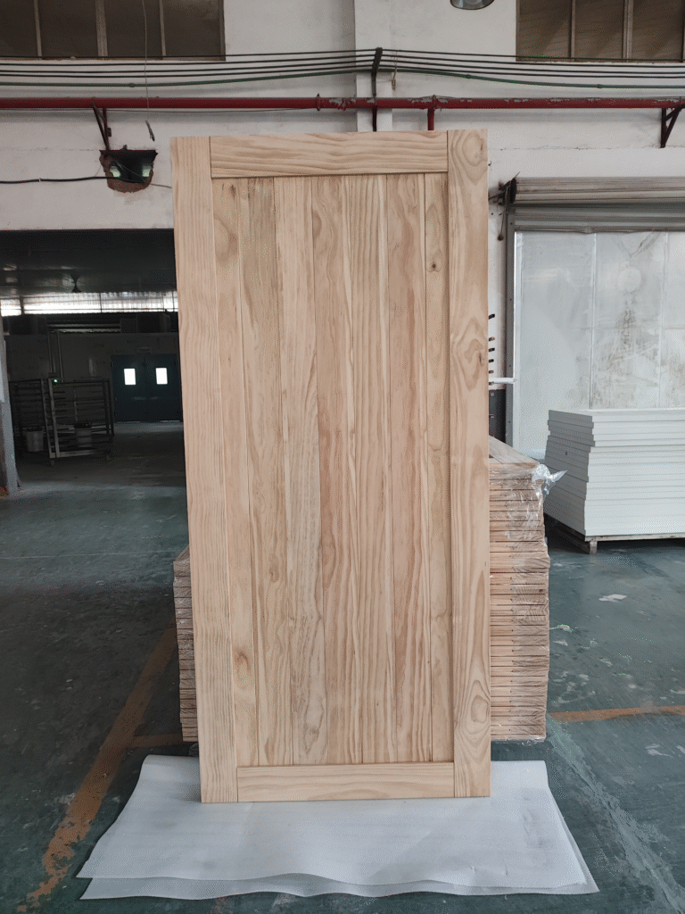 Solid wood farmhouse door with vertical planks in workshop