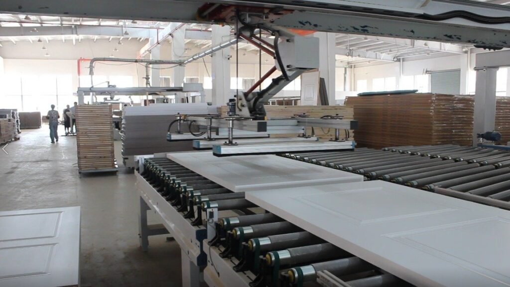 Factory production line with white panels on rollers