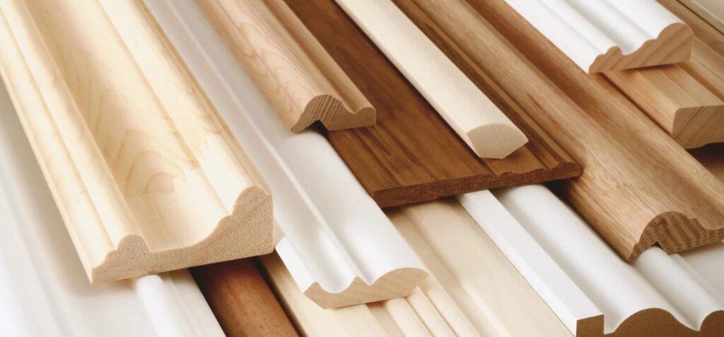 Assorted wood moulding profiles and decorative trim pieces in natural and painted finishes.