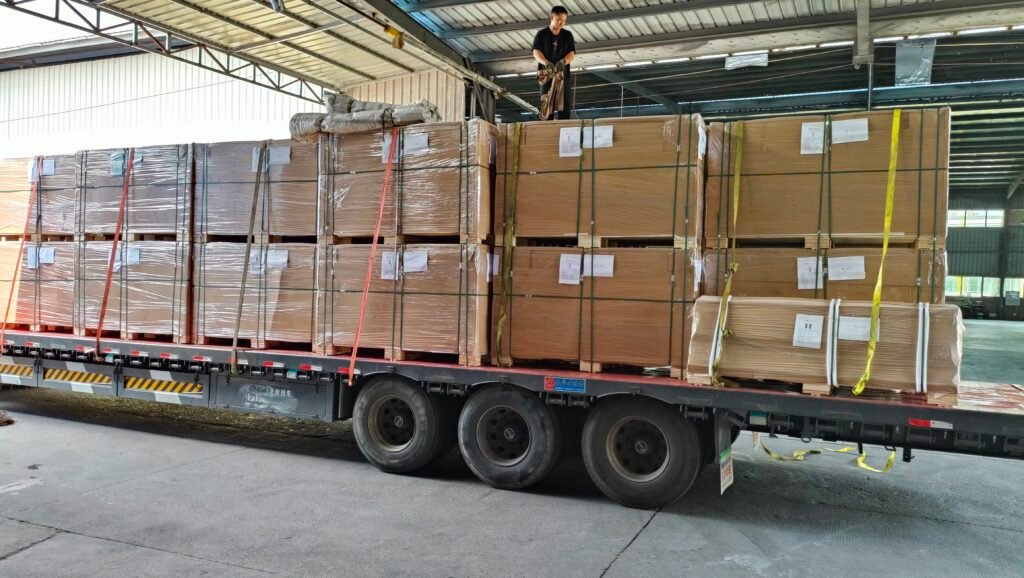 Building material packages loaded on a flatbed truck inside a warehouse