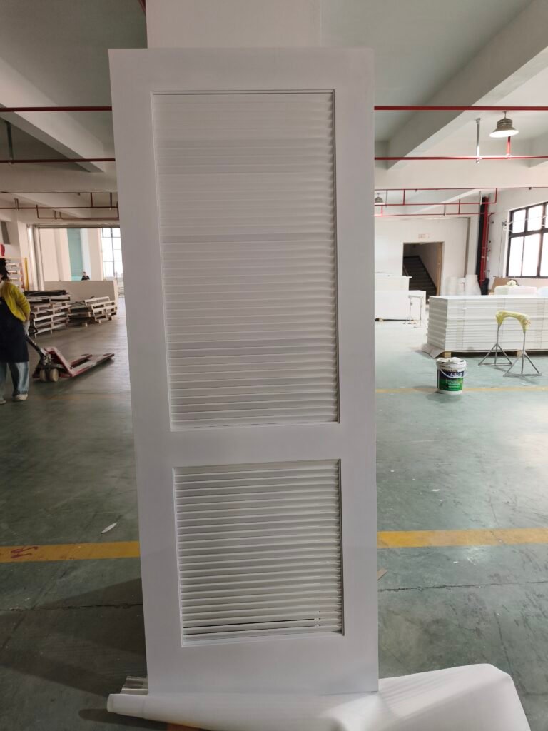 White half-louvered door with two vented panels in a factory setting