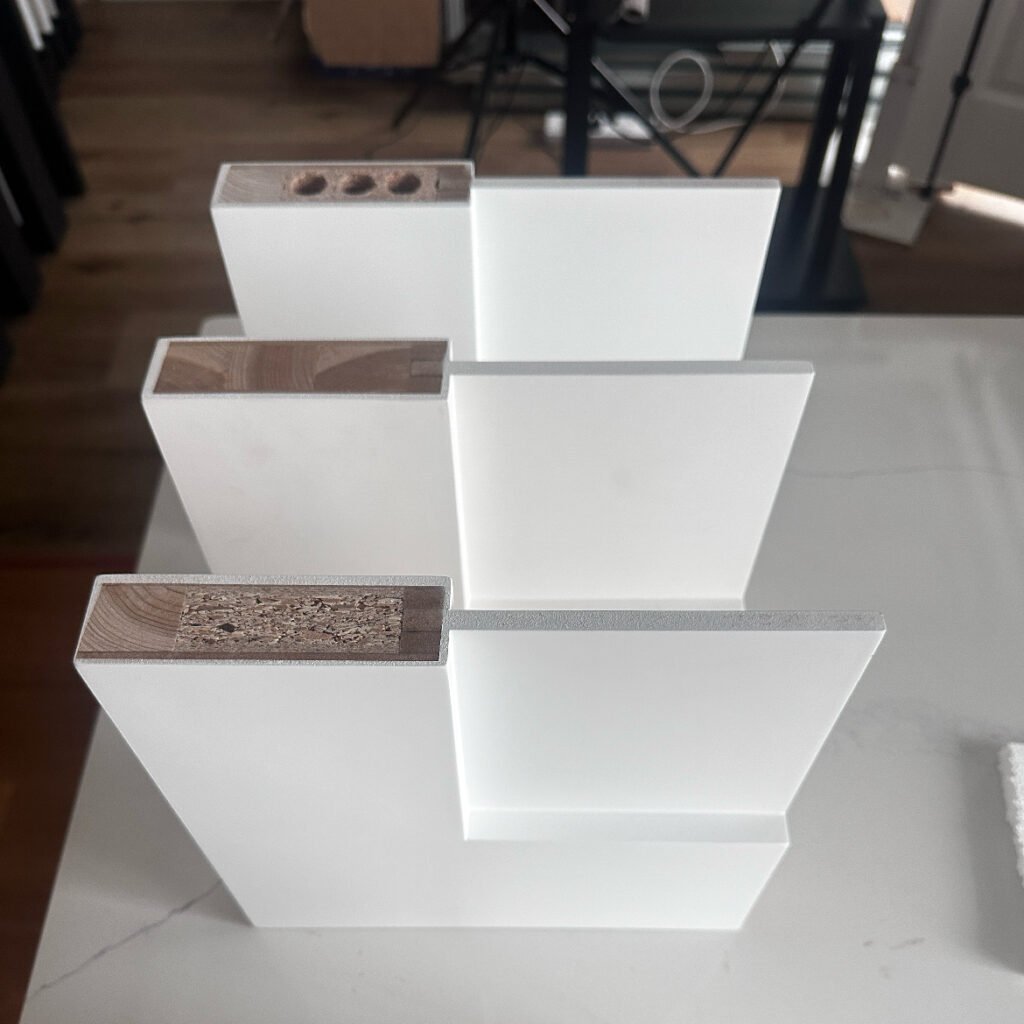 Cross-section comparison of solid wood, MDF, and plywood door panel cores.